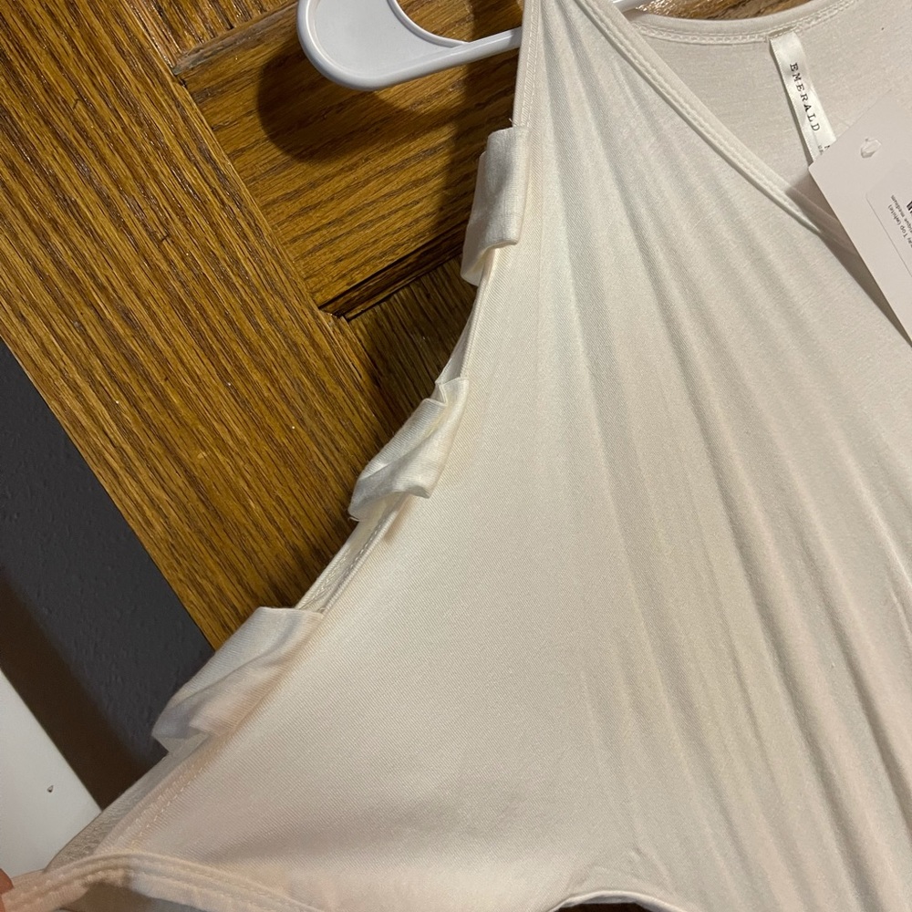 NWT white shirt. Cut out sleeves